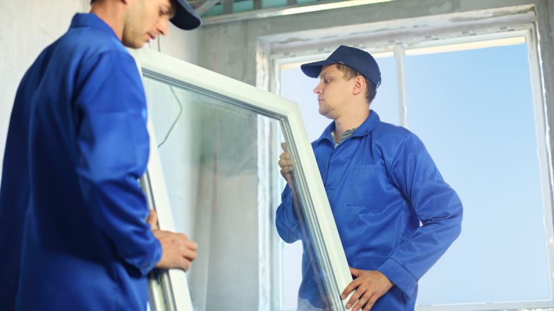 Window installation professional at work